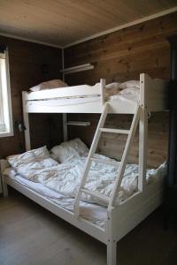 a white bunk bed with a ladder in a room at Myrkdalen Resort Årmotssteien in Vossestrand