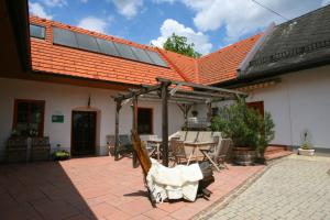 a house with a statue of a chicken on a patio at Buchgrabenhof in Windisch Minihof