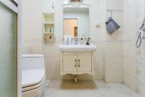 a bathroom with a sink and a toilet and a mirror at Chengdu.Chunxi.Road in Chengdu