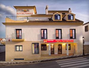 a building on the corner of a street at Hotel Ruta del Poniente in Cuesta de la Palma