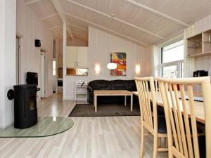 a living room with a couch and a table at 6 person holiday home in GROEMITZ in Grömitz