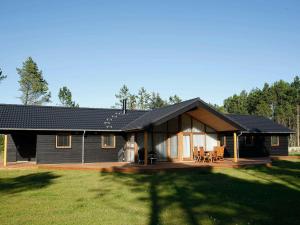 a large house with a porch and a patio at Four-Bedroom Holiday home in Jerup 3 in Jerup