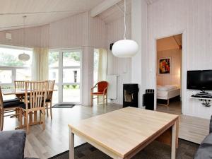 a living room with a table and a dining room at 6 person holiday home in GROEMITZ in Grömitz