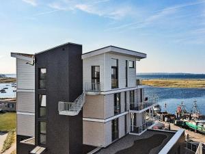 a building with balconies on the side of a body of water at 6 person holiday home in Wendtorf in Wendtorf