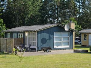 a small blue shed with a satellite at 5 person holiday home in Ans By in Ans