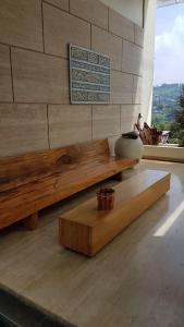 a wooden bench in a room with a window at Bukit Dago Palace 22 in Bandung