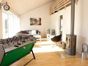 sala de estar con mesa de futbolín verde frente a la chimenea en 10 person holiday home in Brovst, en Brovst