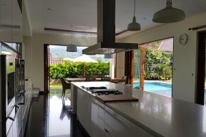 a kitchen with a white counter top and a pool at Bukit Dago Palace 22 in Bandung