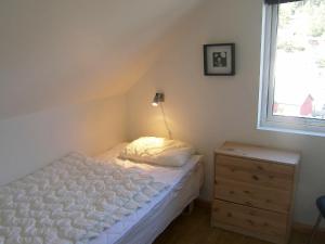 a small bedroom with a bed and a window at 6 person holiday home in Sørbøvåg-By Traum in Sørbø