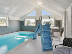 a swimming pool with a slide in a house at 24 person holiday home in Stege in Stege