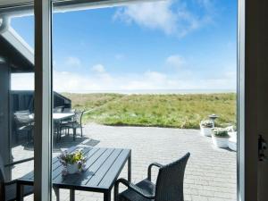 ブラーバンドにある6 person holiday home in Bl vandの海の景色を望むパティオ(テーブル、椅子付)