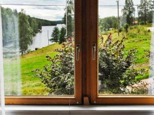 a window with a view of a field of flowers at 6 person holiday home in BENGTSFORS in Näs