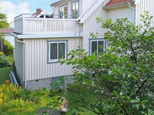a house with a balcony on the side of it at 4 person holiday home in Sk rhamn in Skärhamn