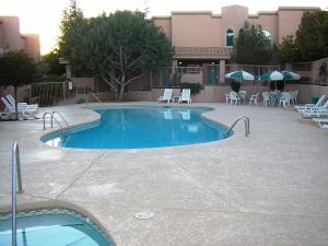 a pool with a pool table and chairs in it at Sedona Springs Resort, a VRI resort in Sedona