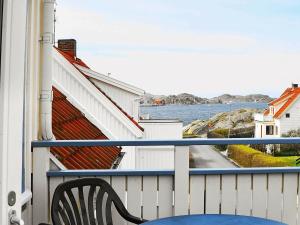 a balcony with a chair and a view of the water at 4 person holiday home in Sk rhamn in Skärhamn