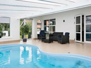 a large swimming pool in a living room with furniture at 8 person holiday home in Ebeltoft in Ebeltoft