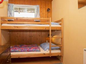 two bunk beds in a room with a window at 5 person holiday home in Silkeborg in Silkeborg