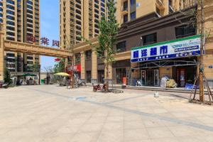 an empty street in a city with tall buildings at Baoding Lianchi·Baoding East Station· in Baoding