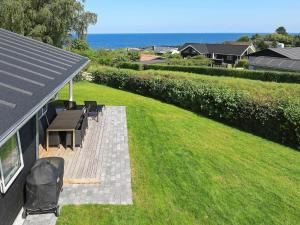 a backyard with a picnic table and a bench at 16 person holiday home in Alling bro in Rygård Strand