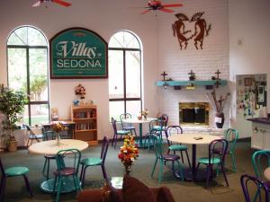 a restaurant with tables, chairs, and tables in it at Sedona Springs Resort, a VRI resort in Sedona
