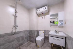 a bathroom with a toilet and a sink at Baoding Lianchi·Baoding East Station· in Baoding +17 photos