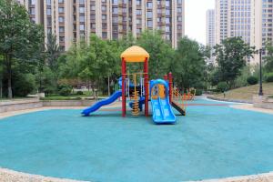 a playground in a park with blue water at Baoding Lianchi·North China Electric Power University· in Baoding