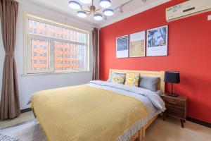 a red bedroom with a bed and a window at Baoding Jingxiu·Beiguo Shopping Mall· in Baoding