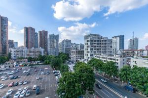 a city with cars parked in a parking lot at [Roader] Wuhan Jiang'an District, Dazhi Road in Wuhan