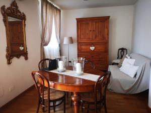 a room with a table with chairs and a bed at Casa Carla, immersa nel verde dei colli Bolognesi in Sasso Marconi