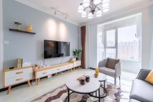 a living room with a tv and a couch at Baoding Lianchi·North China Electric Power University· in Baoding