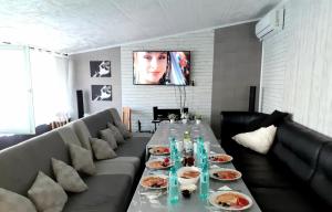a living room with a long table with plates of food at Guest Rooms Simona in Opanets