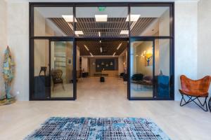 a room with glass doors and a rug on the floor at Marina Burgas Hotel in Burgas