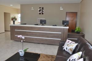 a lobby with a reception desk with a couch at Santa Rosa Hotel in Juazeiro do Norte