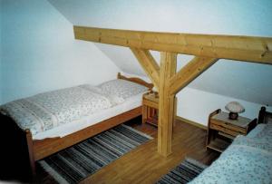 a bedroom with a bed with a wooden canopy at Ferienhaus Grabs in Lichtenhain
