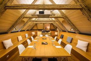 una sala de conferencias con una larga mesa de madera y sillas en Bellevue hotel Karlov en Benešov