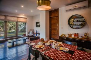 a dining room with a table with food on it at Rock Villa by Baaya in Mussoorie