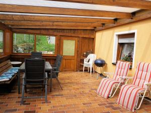 a patio with chairs and a table and a table and chairs at Haus Burgblick in Obertrubach