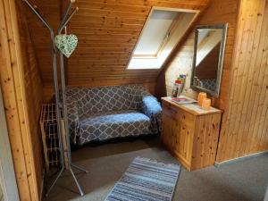 a small room with a chair and a mirror at Haus Burgblick in Obertrubach