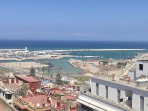 a view of a city with a harbor and the ocean at Appartement hyper centre de Tanger (Boulevard Pasteur) in Tangier