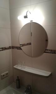 a bathroom with a mirror and a sink at Hotel Garni Post in Grainau