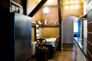 a kitchen with a table with chairs and a refrigerator at Spacious Klaipeda Apartment EV in Klaipėda