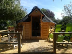 a large wooden cabin with a pitched roof at Camping Loisirs Des Groux in Mousseaux-sur-Seine