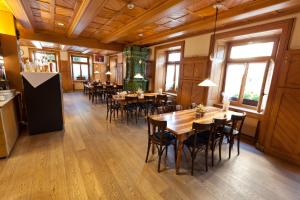 a dining room with wooden floors and tables and chairs at Hotel Bären in Rothenburg +46 photos