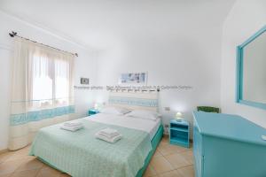Ένα ή περισσότερα κρεβάτια σε δωμάτιο στο Sardinia Blu Residence