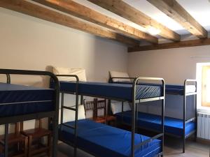 a room with four bunk beds in it at Albergue Orion in Castrojeriz