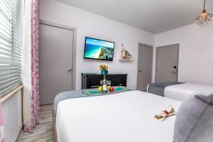 
a bedroom with a television and a bed at Whitelaw Hotel in Miami Beach

