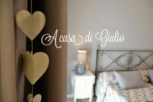 a bedroom with a bed with two hearts on the wall at Appartamento Orvieto A casa di Giulio in Orvieto