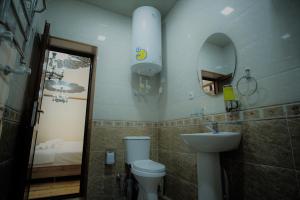 a bathroom with a toilet and a sink and a mirror at Khalima in Bukhara +26 photos