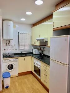 a kitchen with a white refrigerator and a dishwasher at Apartamento Altafulla in Altafulla