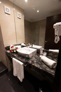 a bathroom with a sink and a mirror at Amerian Rafaela Hotel in Rafaela